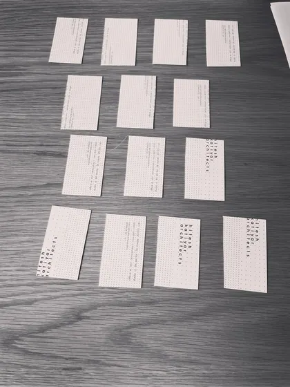 A close-up of our business cards being used as modular units to design a flooring layout. Good ideas can come from anywhere, and we are always ready to improvise.