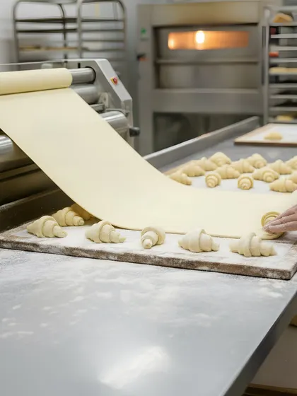 Rolled croissant dough and a dough sheet appear in our catalogue visual of pastry layers in progress.