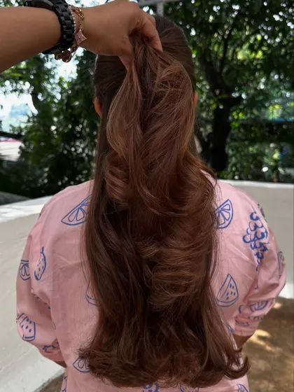 A ponytail shot showing the layers and highlights that add confidence.
