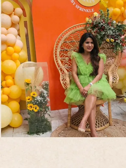 The beautiful mother-to-be at her 'Ray of Sunshine' themed baby shower. I used a peacock chair and a backdrop of warm orange and yellow balloons to create a radiant and joyful photo spot.