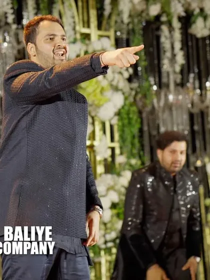 A close-up of one of the groomsmen, pointing to the crowd and bringing the energy. It's these small details that make a performance engaging.