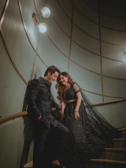 A happy and candid moment between the couple on the staircase.