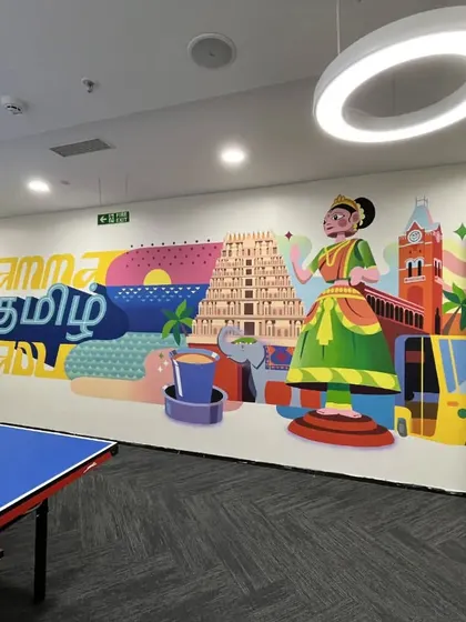 A vibrant "Namma Tamil Nadu" mural adds a splash of local culture to the Kissflow game room. It creates a lively backdrop for the ping-pong table, celebrating regional identity within a global tech office.