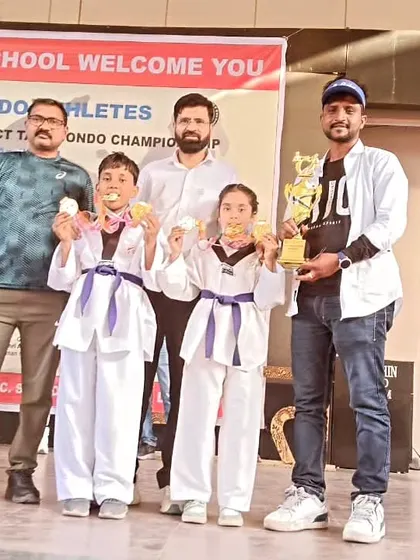 Posing with my gold medalists and their trophy. Their performance was outstanding.