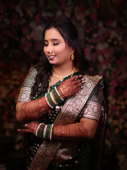 A candid moment showing the bride's intricate henna and soft makeup. The look is cohesive, with every detail complementing the others.