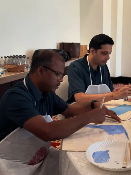 Two gentlemen focused on their artwork during The White Box workshop. It's a great way for colleagues to interact in a different context.