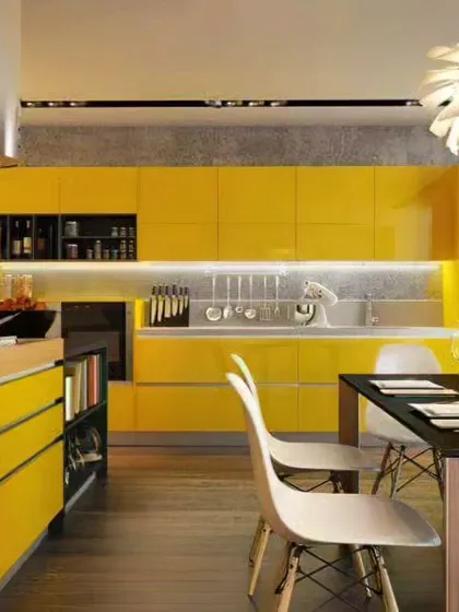 A bold and contemporary kitchen and dining area with vibrant yellow cabinets and a sleek black dining table.
