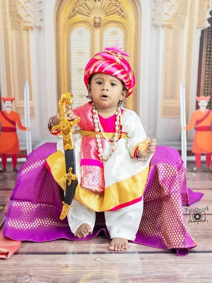A majestic portrait of a little warrior dressed as Chhatrapati Sambhaji Maharaj. This theme is a powerful tribute to Maratha history and pride, complete with a tiny sword and royal attire.