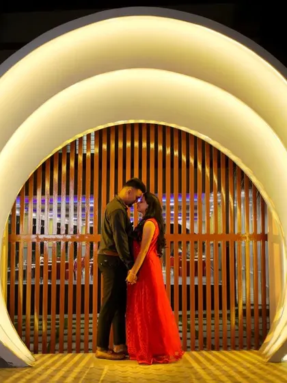 A duplicate of ID 15, this shot captures a romantic moment within a beautifully lit modern arch, perfect for a chic and memorable night shoot.
