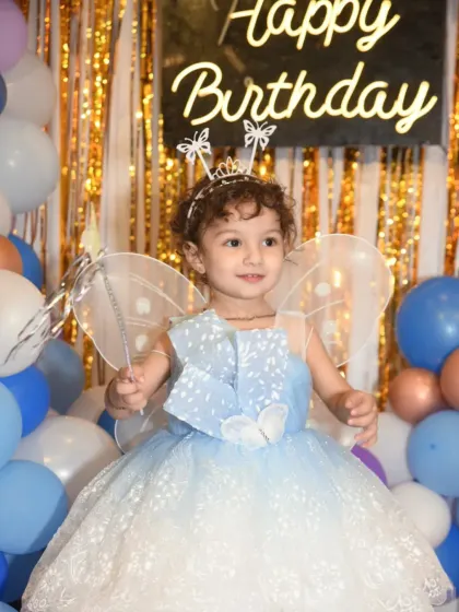 Capturing the magic of childhood birthdays is one of my specialties. Here, the birthday girl is dressed as a fairy princess, complete with wings and a wand, ready to celebrate her special day.