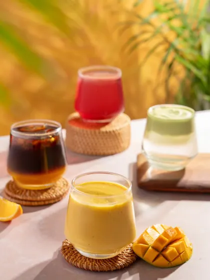 A collection of colorful summer beverages from Blue Tokai, including iced coffee, smoothies, and juices. This shot showcases the variety of their cold drink menu.