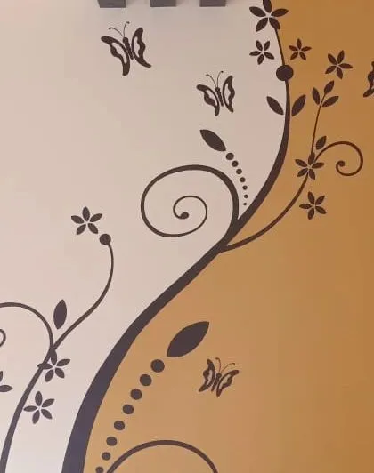 An elegant floral vine stencil design climbing up the wall. This type of flowing pattern can add a graceful and artistic touch to any room.