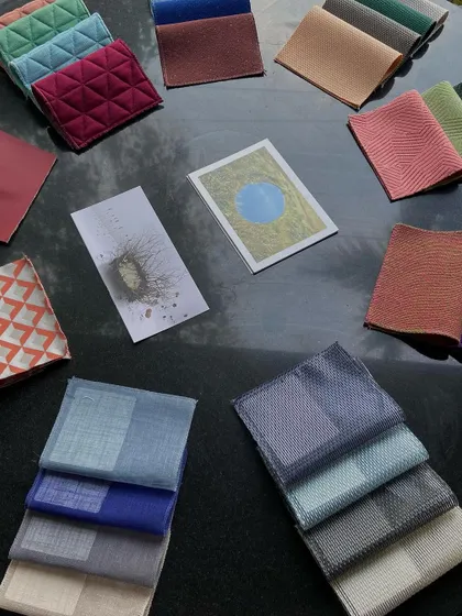 Our team exploring a moodboard of fabric swatches and inspiration images during a creative workshop. This hands-on process of feeling textures and seeing colors together is essential to crafting a cohesive interior scheme.