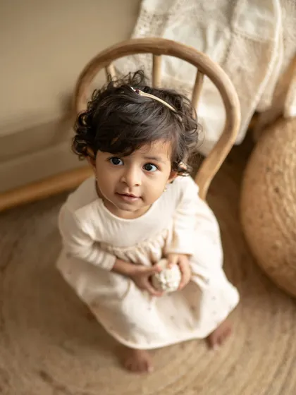 "When mama says no sugar." This little girl's adorable, mischievous expression is a perfect capture of a toddler's personality. A fun and candid solo portrait.