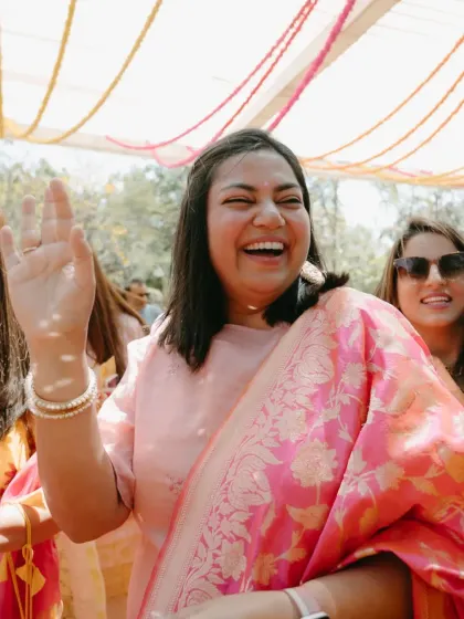 A guest dancing with joy at the Haldi. The celebration is for everyone, and we love seeing the guests have as much fun as the couple.