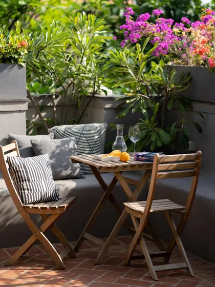 The built-in concrete seating on the terrace is softened with comfortable cushions, creating a perfect spot for lounging.