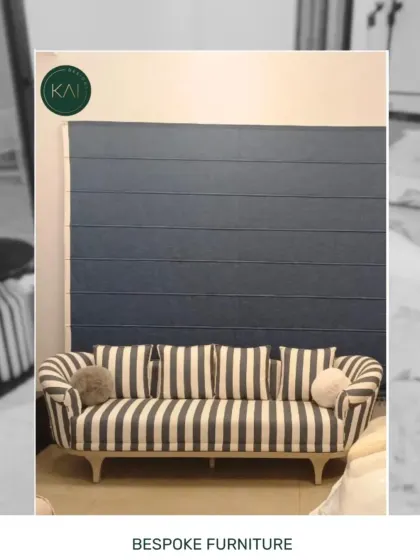 A custom-made sofa with bold stripes, showcasing our ability to work with client-specified fabrics and patterns to create a truly personal piece of furniture.