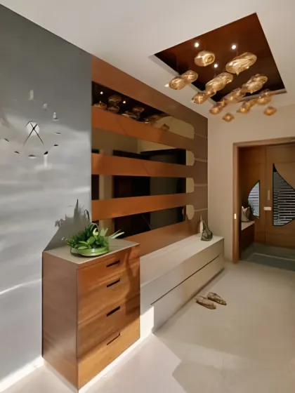 A sleek and modern entryway with a floating console, wood slat details, and a unique ceiling light fixture.