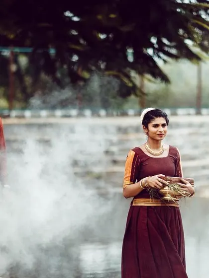 An atmospheric shot using smoke for a dramatic effect. The couple's traditional attire and the bride-to-be's classic makeup look timeless in this setting.