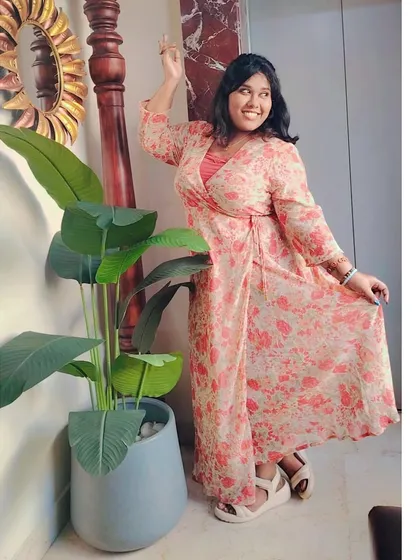 A playful pose in the floral dress. My photoshoots are always about having fun and letting my personality shine through.