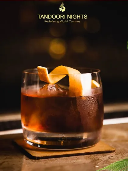 Summer in a glass. This classic dark liquor cocktail with an orange peel twist is an irresistible choice from our seasonal drink selection.