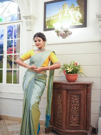 A playful pose in our beautiful pastel blue and yellow saree combination.