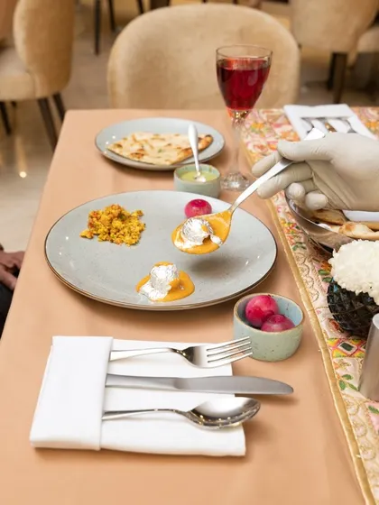 This image captures the fine-dining experience. The focus is on the elegant plating and the sophisticated restaurant ambiance, appealing to customers looking for a special occasion meal.