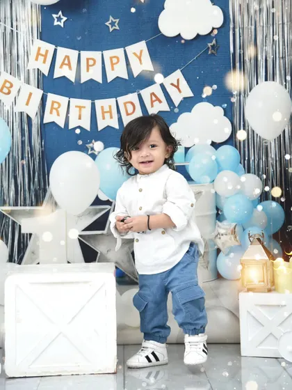 A starry night theme for a special first birthday boy. The blue and silver decorations create a magical, dreamy backdrop for his celebration.