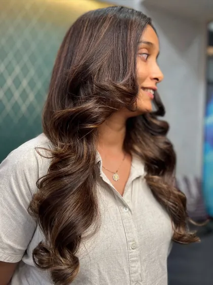 The side profile of this cocoa and gold look shows how the layers and colors work together to create a seamless, flowing style that looks effortlessly beautiful.