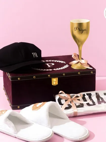 Another look at the groom's woman hamper, showing the personalized items arranged with the elegant burgundy trunk-style box.