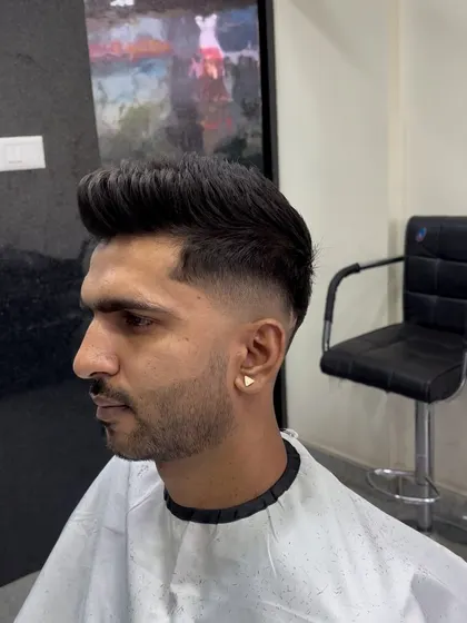 A side profile of a classic pompadour with a sharp fade.
