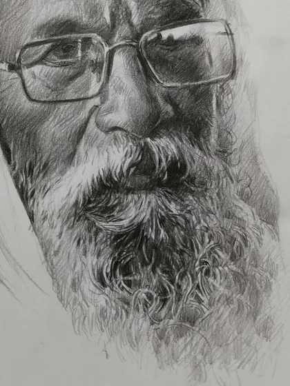 A detailed pencil sketch focusing on the eyes and beard of an elderly man. The texture of the hair and the wisdom in the eyes are what I love to capture.