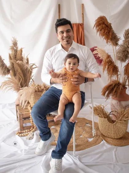 A proud dad with his little one. This portrait, set against our boho backdrop, is a wonderful keepsake of this special time.