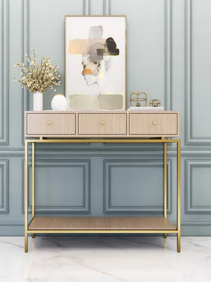 A classic console design with a light wood finish and a gold frame, offering both drawers and a lower shelf for storage and display.
