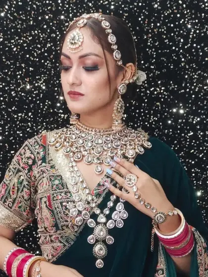 A beautiful example of a layered Polki and Kundan set. The combination of a choker and a long, cascading necklace adds depth and grandeur, perfect for a bridal lehenga.