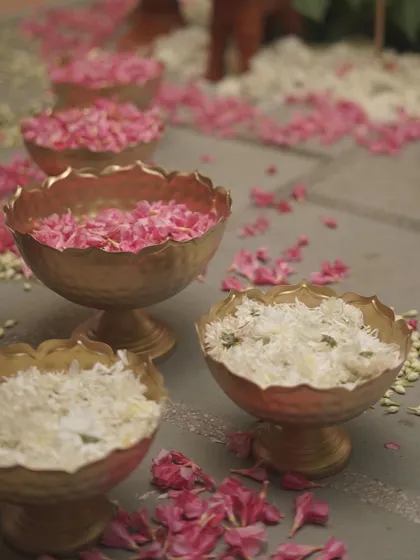 Brass bowls filled with fresh white jasmine and pink rose petals. We use these throughout the venue for guests to shower blessings and to add fragrance and color to the space.