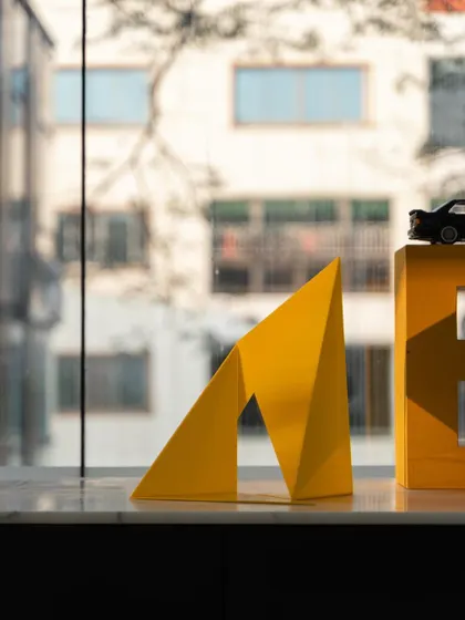 Another shot of the "Yello" model, this time with a model car, giving a sense of the final scale. Our design process is rigorous, involving digital analysis, prototyping, and careful oversight to bring ambitious ideas to life.