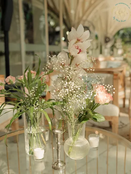 Delicate floral arrangements in glass vases serve as simple yet beautiful centerpieces. Sometimes, less is more when it comes to creating an elegant tablescape.