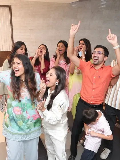 The sheer excitement of winning a game at the purple bow-themed baby shower.