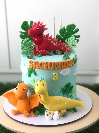 Another angle of the colorful dinosaur cake, perfect for a dino-themed party.