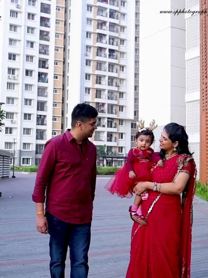 An urban setting can provide a modern backdrop for a family photoshoot. This candid walking shot captures a natural interaction between the family members.