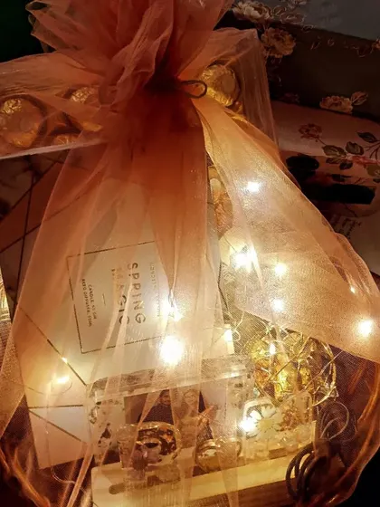 I also create custom gift hampers for other special occasions like Valentine's Day. This one is packed with chocolates, a notebook, and handmade resin gifts, all wrapped up with fairy lights.