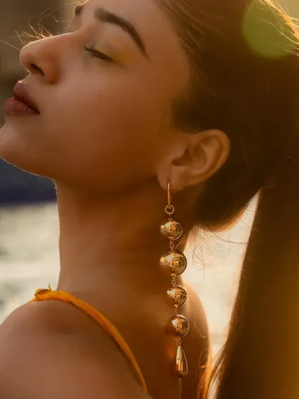 Golden hour by the pool, made even better with my Golden Tassel Drop Statement Earrings. They catch the light perfectly.