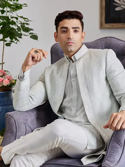 The complete look, paired with crisp white trousers, is perfect for a destination wedding or a summer evening event. It’s a sophisticated blend of comfort and high fashion.