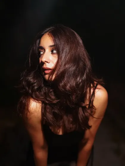 This shot captures a fleeting, in-between moment. The movement in the hair and the off-camera gaze make it feel authentic and mysterious.