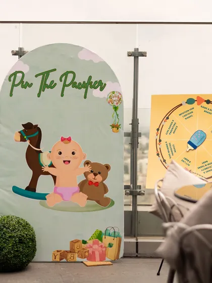 Fun baby shower games like "Pin the Pacifier" set up on a rooftop. I love to organize engaging activities that get all the guests involved in the celebration.