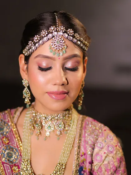 A close-up of a pastel bride. The soft pink eyeshadow and nude lip create a dreamy and romantic feel.
