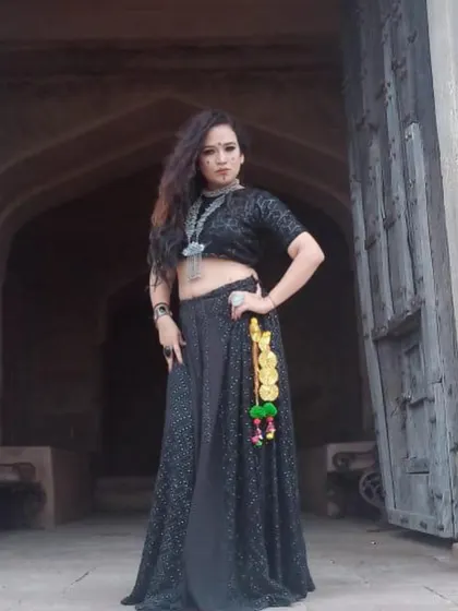 A full-length shot of the singer's 'Jogan' outfit. The addition of colorful tassels (parandi) to the lehenga added a touch of folk detail to the otherwise dark and glamorous look.