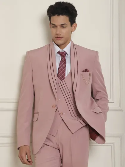 A detailed view of the lapel and brooch on our pastel pink suit, showcasing our attention to unique design elements.
