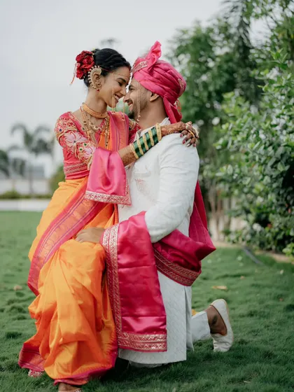 A romantic pose with him kneeling. It’s a gesture of love and respect, beautifully captured in their traditional attire.